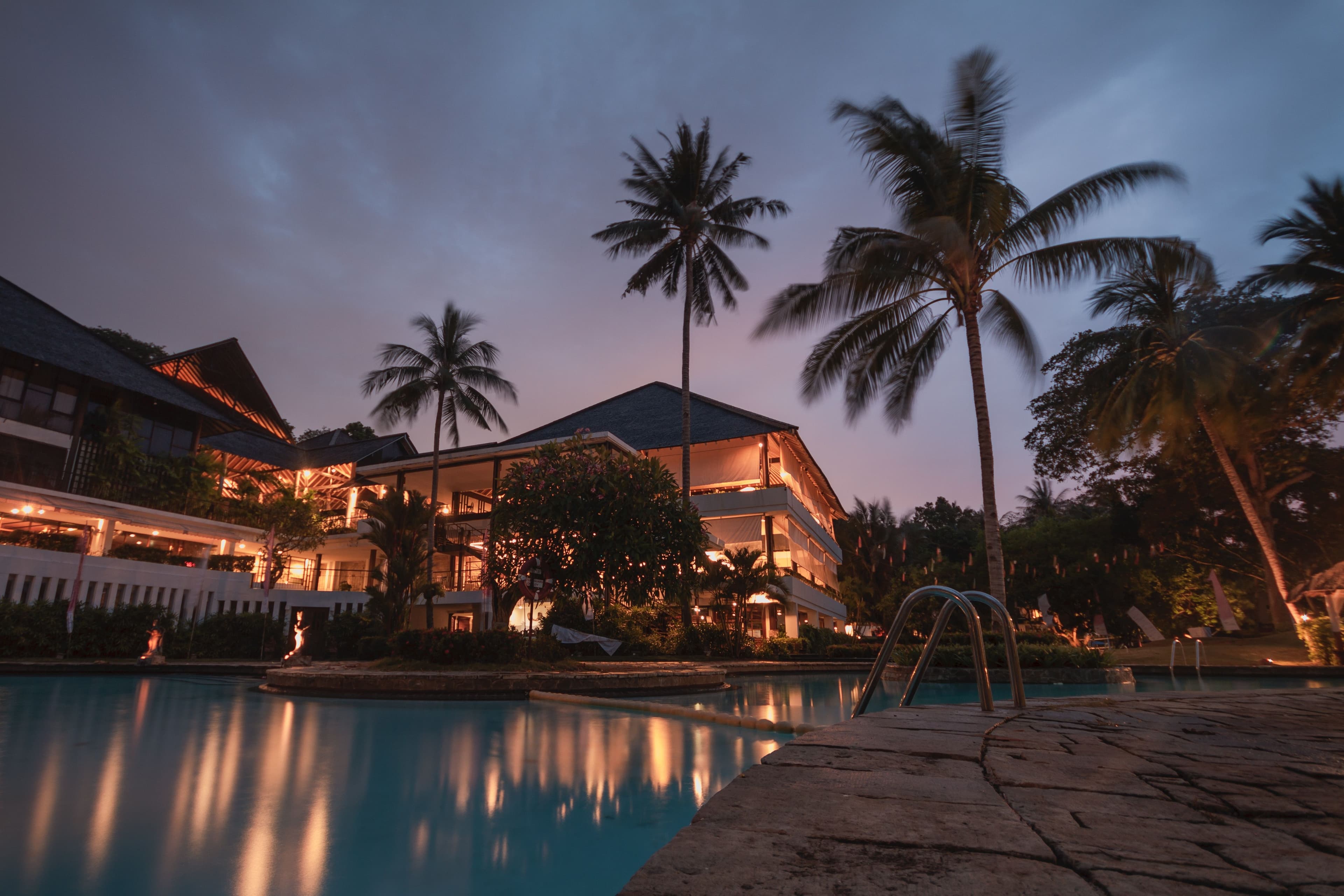 Luxury hotel pool at sunset